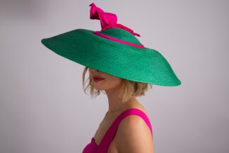 'Powerhouse': Wide brim straw hat with dramatic hot pink silk flyaway bow,
